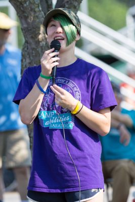 blind child speaking in a microphone