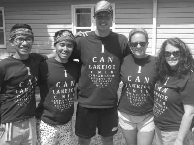 Photo of Corey and a group of people smiling.