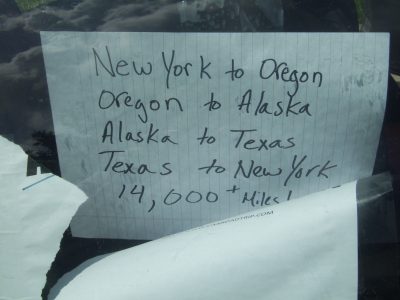 A piece of looseleaf paper that says New York to Oregon, oregon to Alaska, Alaska to Texas, Texas to New York, 14000+ Miles!