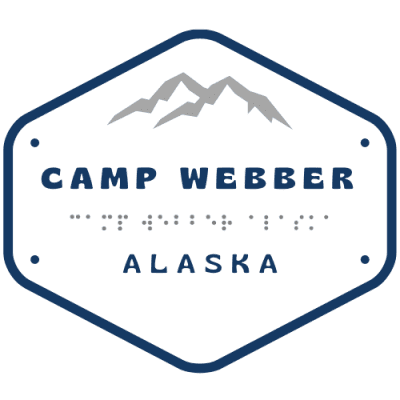 Camp Webber Alaska logo. Hexagon shape plate with mountains and Camp Webber Alaska written on the plate with Camp Webber Alaska brailled written underneath.